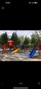 a playground with colorful slides in a park at 2 комнатная квартира студио на Иссык куле in Chok-Tal