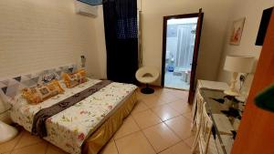 a bedroom with a bed and a door to a bathroom at Il Mirto E La Rosa in Arenella