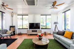 a living room with a couch and a tv at Casa da Calma in Vale do Lobo