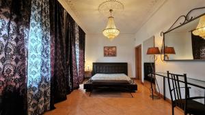 a bedroom with a bed and a chandelier at Silver Village Residence in Maceira