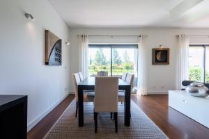 a dining room with a table and chairs at L'Orangerie in Vilamoura