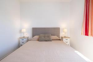 a bedroom with a large bed with two night stands at Villa Terrenito Private Pool by AORA STAY in Fuengirola