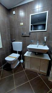 a bathroom with a toilet and a sink at Il Mirto E La Rosa in Arenella
