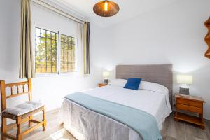 a bedroom with a large bed and a window at Villa Terrenito Private Pool by AORA STAY in Fuengirola