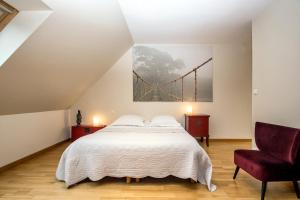 a bedroom with a bed and a bridge on the wall at La Canopée des Pins in Cléder