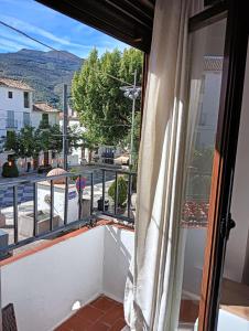 a balcony with a view of a street at La Casa de la Plaza in Güéjar-Sierra