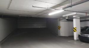 a parking garage with a car parked in it at X3 Luxury OldTown Apt w Free Garage, Netflix, Supermarket, FastWifi in Košice