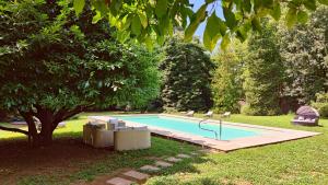 uma piscina num quintal com uma árvore em Casa Cassettari, Apartment with Garden and pool em Ghivizzano