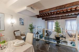 a dining room with a table and chairs at CASA EDA, Modern Contemporary Central Apartment inside the Walls of Lucca in Lucca