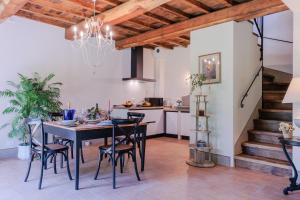 a kitchen and dining room with a table and chairs at La Vaseria Country House with Secret Garden and pool in Ghivizzano