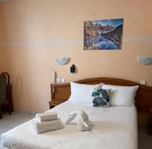 Ένα ή περισσότερα κρεβάτια σε δωμάτιο στο Hôtel Elaïa