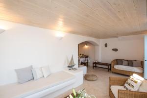 a living room with a couch and a table at Traditional Cycladic House 2 in Mykonos in Mykonos