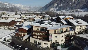 an aerial view of a town with snow covered buildings at Aparthotel AlpTirol in Kaltenbach