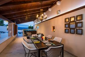 an open dining room with a table and chairs at Villa Jasmine in Dol