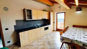 a kitchen with a sink and a table with a table cloth at La Majon in Colle Santa Lucia