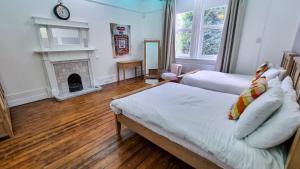 a living room with a bed and a fireplace at 6 Bed Mansion Sleeps 20 Free Parking in Ashton under Lyne