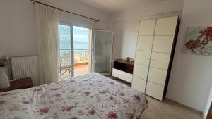 a bedroom with a bed and a dresser and a window at Petro's House in Nikiti