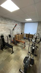 a gym with several exercise equipment in a room at готель ПРИБЕРЕЖНИЙ in Pavlohrad