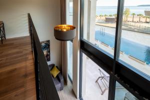 a hallway with a view of the ocean from a house at Invictus Hotel in Budva