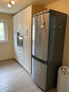 a kitchen with a stainless steel refrigerator in a kitchen at Hiša Tartinijeva in Izola