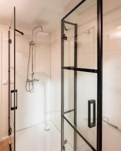 a shower with a glass door in a bathroom at Wellness Boutique 5 pers. NEW 2022 in Zuna +11 photos