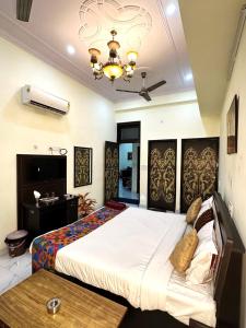 a bedroom with a large bed and a table at Jaipur Heritage Haveli in Jaipur