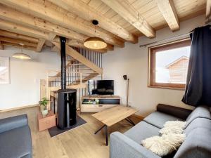 a living room with a couch and a table at Chalet Le Charbonnel in La Toussuire