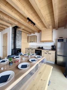 a kitchen with a table with plates on it at Chalet L'Argentière in La Toussuire