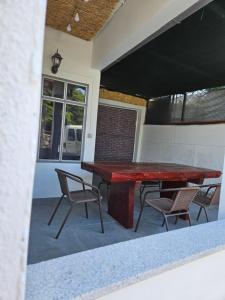 a red table and chairs on a patio at Apartman Selce in Selce +2 photos