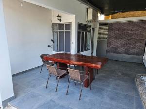 a wooden table and chairs on a patio at Apartman Selce in Selce