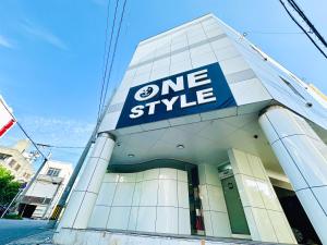 a one style sign on the side of a building at One Style in Naha