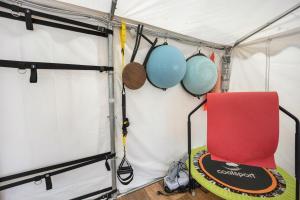 a room with a red chair in a tent at Studio Pelagos in Pompeiana