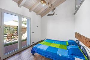 a bedroom with a bed and a large window at Studio Pelagos in Pompeiana +17 photos