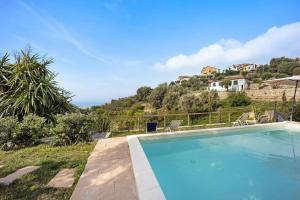 a swimming pool with a view of the ocean at Studio Pelagos in Pompeiana