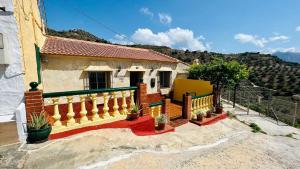 a house with a balcony with a view of a mountain at Casa Godoy con piscina by At Home Costa del Sol in Río