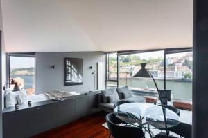 a living room with a couch and a glass table at MY DOURO VIEW Stylish Gem River Front in Vila Nova de Gaia