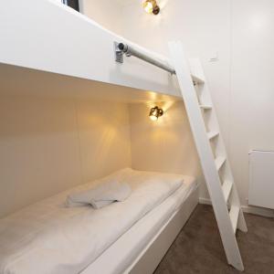 a bed in a small room with a ladder at Houseboat - Paviljoenwei 4 Sneek Offingawier in Offingawier
