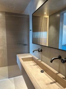 a bathroom with a sink and a mirror at Syros Soul Private Pool Suites in Ermoupoli