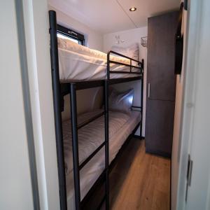 a couple of bunk beds in a room at Houseboat Marina Mookerplas 4-6 persons roof terrace in Plasmolen