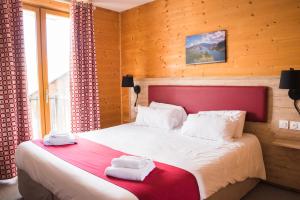a bedroom with a large bed with towels on it at Hôtel Espace Montclar in Montclar +108 photos