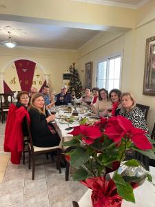 a group of people sitting at a dinner table at Hotel Aroma in Përmet
