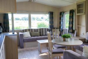 a living room with a couch and a table at Mobile home by the Regge I 4 people in Zuna