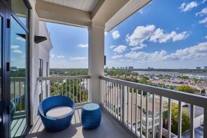 a balcony with two chairs and a view of the city at Hotel Effie Sandestin Resort, Autograph Collection in Destin
