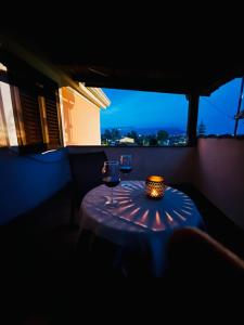 a table in a dark room with two glasses of wine at Appartamento Girasole in Girasole