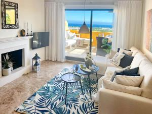 a living room with a couch and a table at 62 - Penthouse in Los Almendros with fantastic vie in Marbella