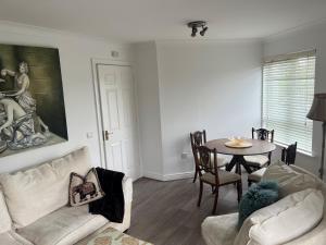 a living room with a couch and a table at Cosy 2 Double Bed Apartment in Swords