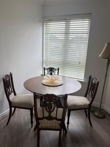 a dining room with a table and two chairs at Cosy 2 Double Bed Apartment in Swords