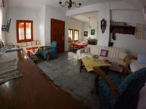 a living room with a couch and a table at Katafigio Home in Tsagkarada Village in Tsagarada