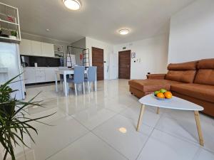 a living room with a couch and a table at Comfort for two in St. Paul's Bay
