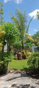 a park with palm trees and a field of grass at Mem Homestay 